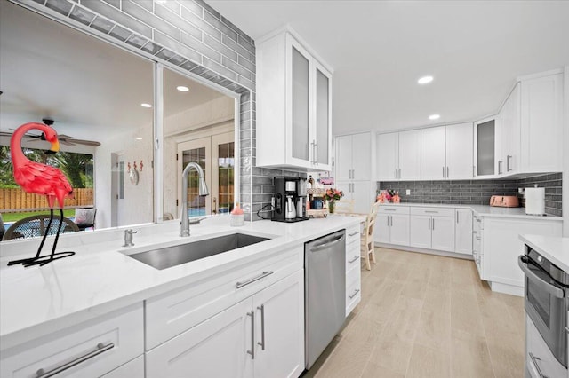 509 Oak Ter, Jupiter, FL 33458 - kitchen with range, backsplash, stainless steel dishwasher, and a sink