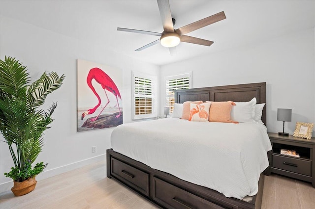 509 Oak Ter, Jupiter, FL 33458 - bedroom with light wood finished floors, baseboards, and ceiling fan