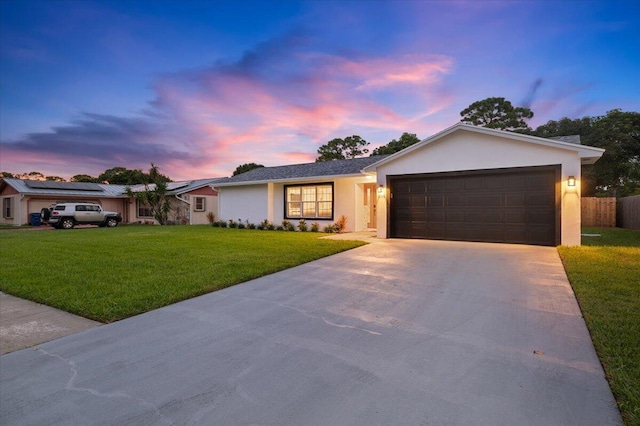 509 Oak Ter, Jupiter, FL 33458 - ranch-style house with concrete driveway, an attached garage, fence, a yard, and stucco siding