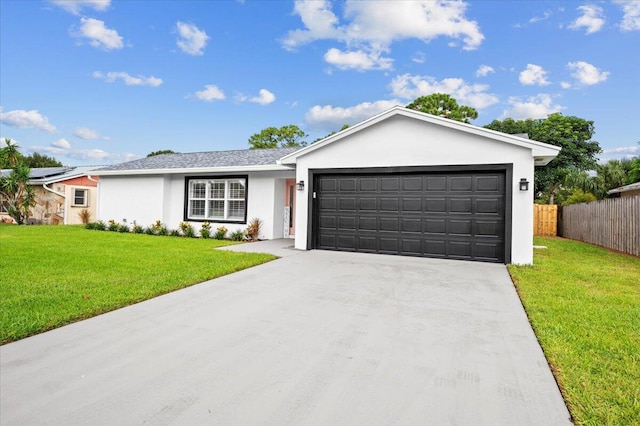 509 Oak Ter, Jupiter, FL 33458 - ranch-style home with a front lawn, driveway, an attached garage, fence, and stucco siding