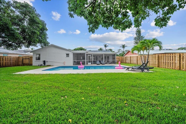 509 Oak Ter, Jupiter, FL 33458 - view of pool with a fenced backyard, a sunroom, a yard, and a fenced in pool