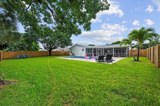 509 Oak Ter, Jupiter, FL 33458 - view of yard with a fenced backyard, a sunroom, a patio area, and a fenced in pool