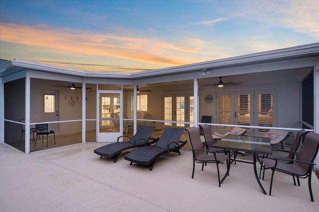 509 Oak Ter, Jupiter, FL 33458 - back of house at dusk featuring ceiling fan, french doors, and a patio area
