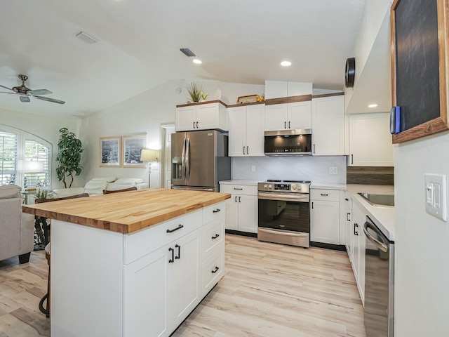 1732 Sunrise Ln, Sebastian, FL 32958 - kitchen with open floor plan, ceiling fan, lofted ceiling, appliances with stainless steel finishes, and visible vents