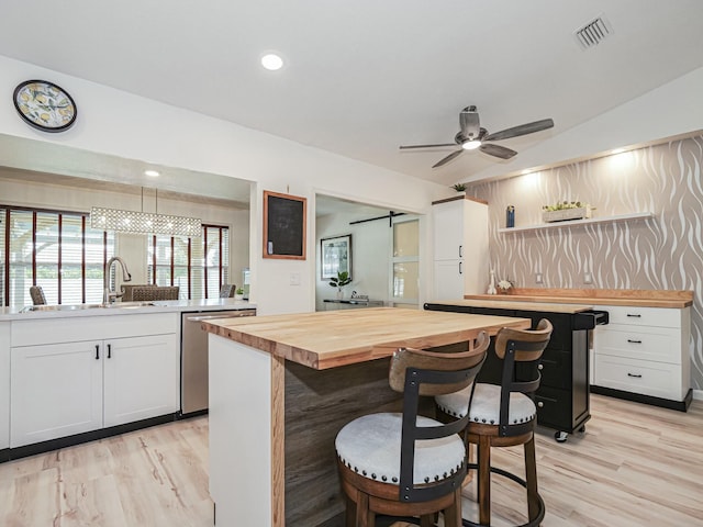 1732 Sunrise Ln, Sebastian, FL 32958 - kitchen with wood counters, vaulted ceiling, light wood-type flooring, and a sink