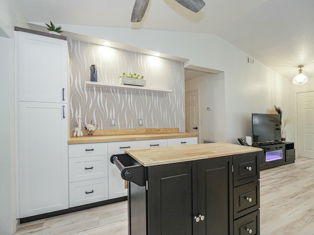1732 Sunrise Ln, Sebastian, FL 32958 - kitchen featuring white cabinets, vaulted ceiling, open shelves, dark cabinets, and butcher block counters