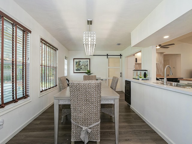1732 Sunrise Ln, Sebastian, FL 32958 - dining space featuring a barn door, visible vents, baseboards, ceiling fan with notable chandelier, and dark wood-type flooring
