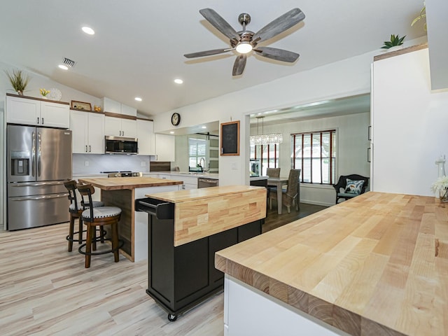 1732 Sunrise Ln, Sebastian, FL 32958 - kitchen featuring butcher block counters, a wealth of natural light, light wood-style floors, and stainless steel appliances
