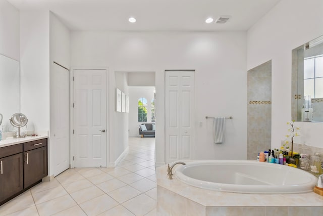 full bathroom with tile patterned flooring, a closet, a bath, vanity, and visible vents