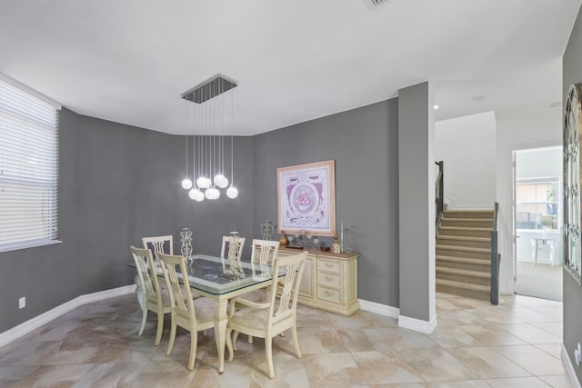 dining area with baseboards, a notable chandelier, and stairs