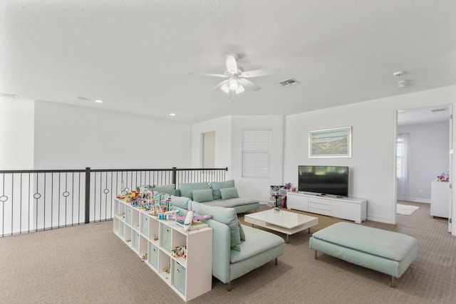 carpeted living area featuring ceiling fan, recessed lighting, visible vents, and baseboards
