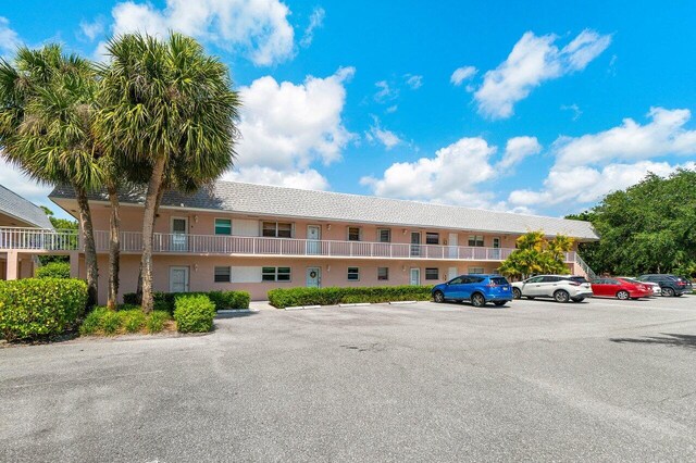 view of property featuring uncovered parking