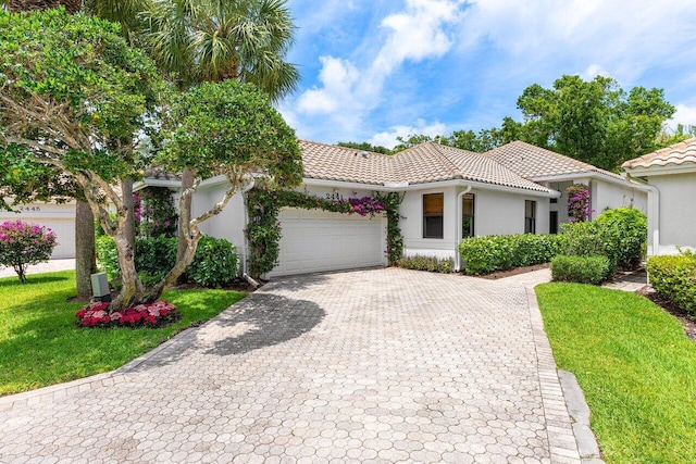 2441 NW 64th St, Boca Raton, FL 33496 - mediterranean / spanish home featuring a garage, a tiled roof, decorative driveway, and stucco siding