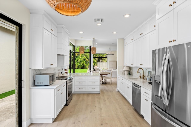 2441 NW 64th St, Boca Raton, FL 33496 - kitchen featuring decorative backsplash, light countertops, a sink, and appliances with stainless steel finishes