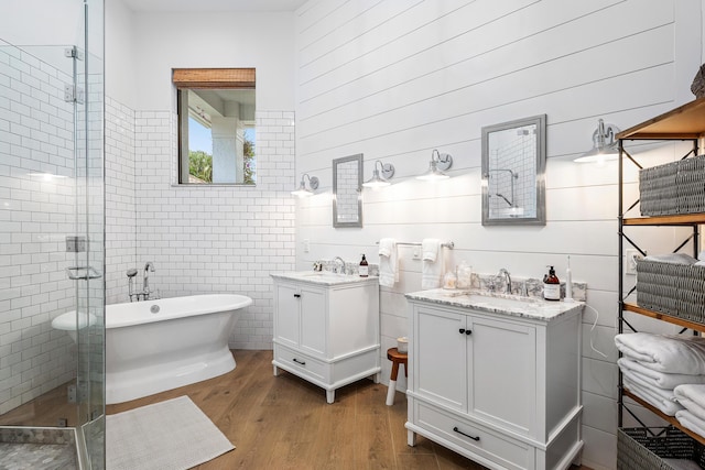 2441 NW 64th St, Boca Raton, FL 33496 - full bath with two vanities, wood finished floors, a sink, and a shower stall