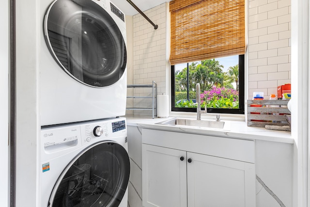 2441 NW 64th St, Boca Raton, FL 33496 - washroom featuring a sink, stacked washer / dryer, and cabinet space