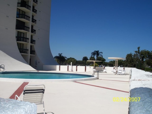 2400 Presidential Way Unit 1803, West Palm Beach, FL 33401 - community pool featuring a patio and fence
