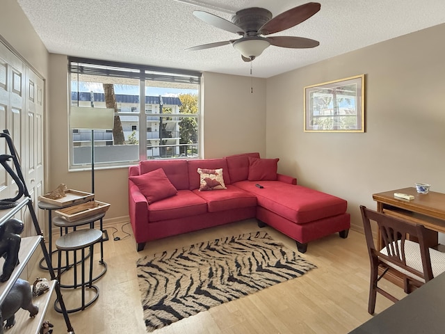 777 S Federal Hwy Unit 209N, Pompano Beach, FL 33062 - living room featuring baseboards, wood finished floors, a ceiling fan, and a textured ceiling