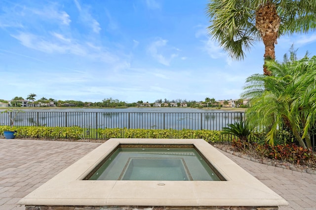 725 Edgebrook Ln, West Palm Beach, FL 33411 - view of swimming pool with a water view, an in ground hot tub, and fence