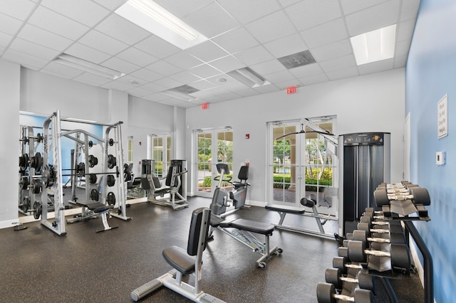 725 Edgebrook Ln, West Palm Beach, FL 33411 - gym with french doors, baseboards, a drop ceiling, and a towering ceiling