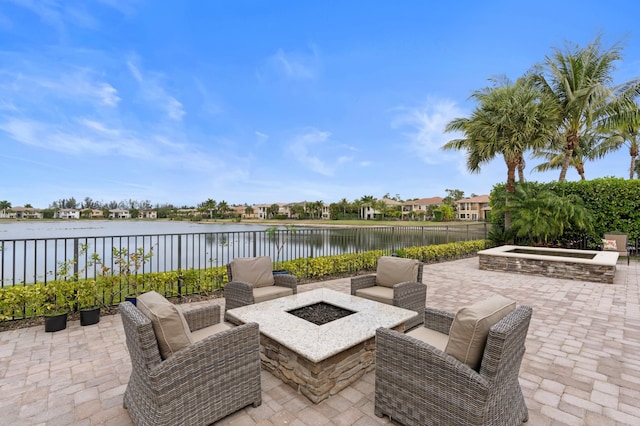725 Edgebrook Ln, West Palm Beach, FL 33411 - view of patio with a water view, fence, and a fire pit