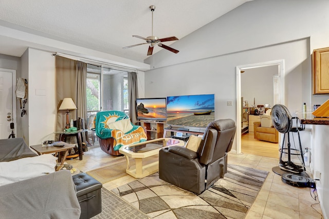 living room with a ceiling fan, light tile patterned flooring, and vaulted ceiling