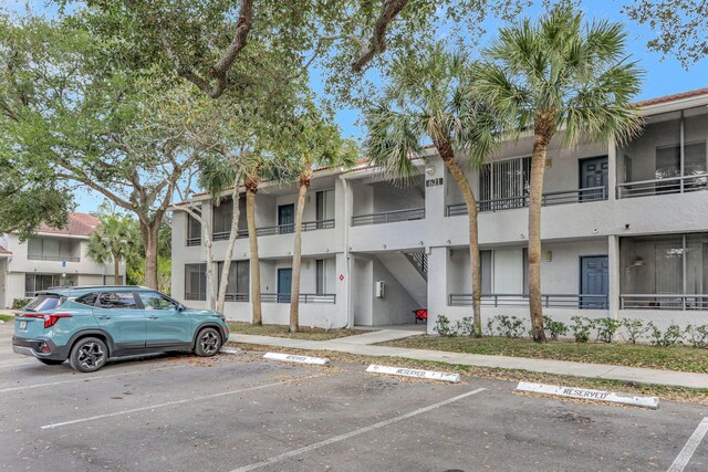 621 Lyons Rd Unit 9201, Coconut Creek, FL 33063 - view of building exterior with uncovered parking
