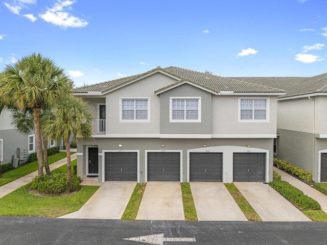 3030 Grandiflora Dr, Greenacres, FL 33467 - view of front facade featuring a garage, a tiled roof, and stucco siding