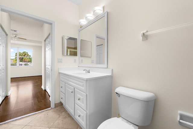3030 Grandiflora Dr, Greenacres, FL 33467 - bathroom featuring tile patterned flooring, toilet, vanity, and a ceiling fan