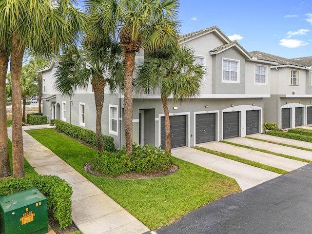 3030 Grandiflora Dr, Greenacres, FL 33467 - multi unit property with stucco siding, concrete driveway, a front yard, and a garage