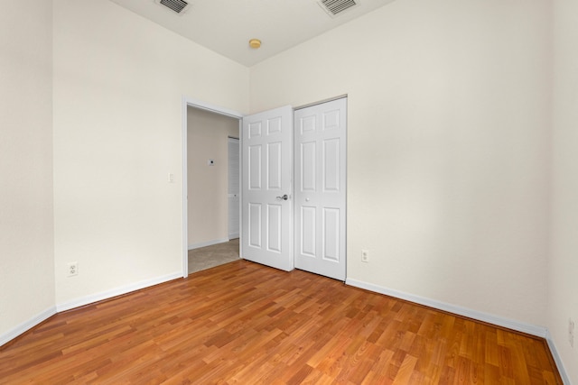 3030 Grandiflora Dr, Greenacres, FL 33467 - unfurnished bedroom with a closet, light wood-style floors, visible vents, and baseboards