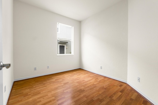 3030 Grandiflora Dr, Greenacres, FL 33467 - empty room with baseboards and light wood-style flooring