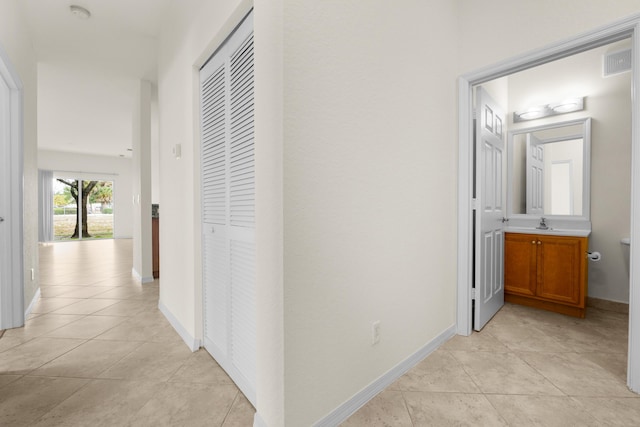 3030 Grandiflora Dr, Greenacres, FL 33467 - hallway featuring visible vents, baseboards, and light tile patterned floors