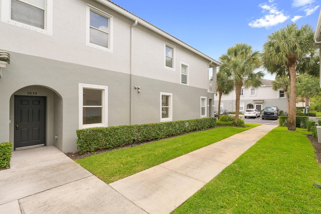 3030 Grandiflora Dr, Greenacres, FL 33467 - view of property exterior featuring a yard and stucco siding