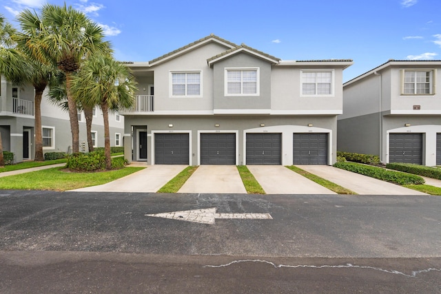 3030 Grandiflora Dr, Greenacres, FL 33467 - view of property featuring a garage, concrete driveway, and stucco siding