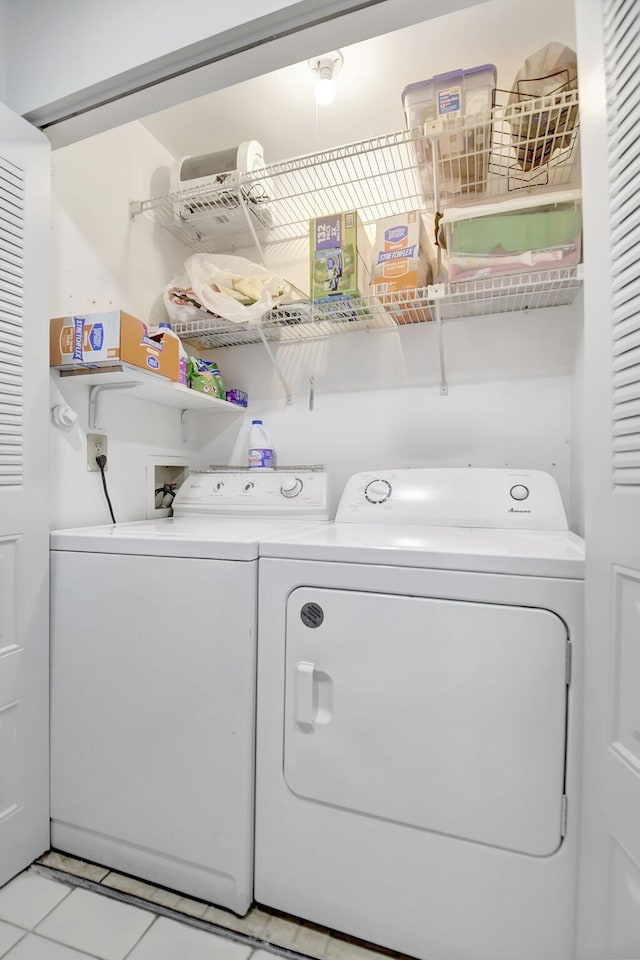 5325 Mariesa Ave, West Palm Beach, FL 33417 - clothes washing area with washer and clothes dryer and light tile patterned floors