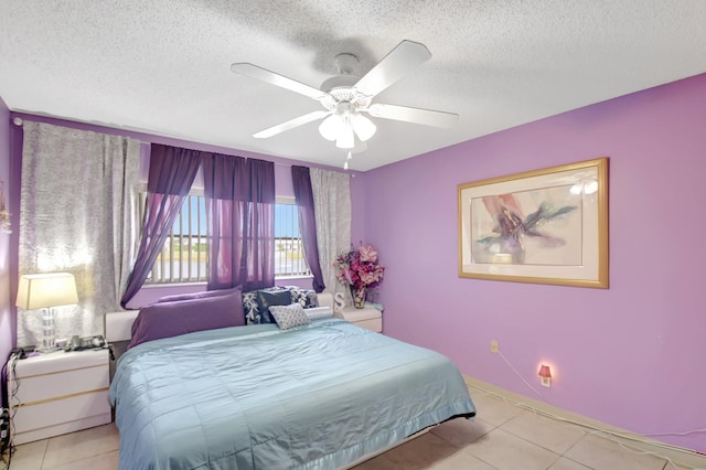 5325 Mariesa Ave, West Palm Beach, FL 33417 - tiled bedroom with a textured ceiling, ceiling fan, and baseboards