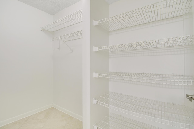 4221 W Mcnab Rd Unit 28, Pompano Beach, FL 33069 - walk in closet with tile patterned flooring