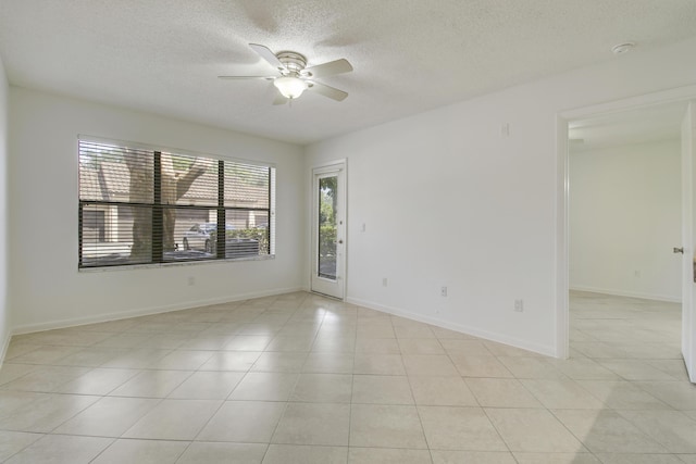 4221 W Mcnab Rd Unit 28, Pompano Beach, FL 33069 - empty room featuring a textured ceiling, baseboards, ceiling fan, and light tile patterned floors