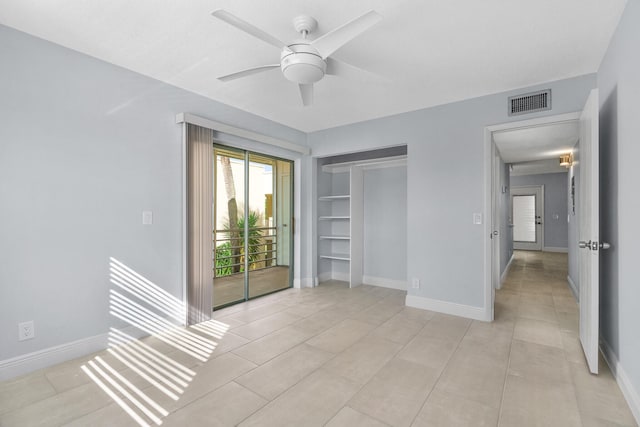 unfurnished bedroom featuring visible vents, baseboards, ceiling fan, and light tile patterned floors