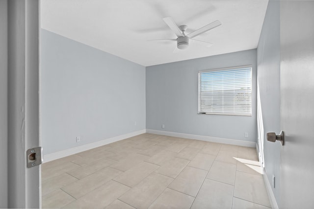 unfurnished room with baseboards and a ceiling fan