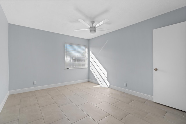 empty room with baseboards and a ceiling fan