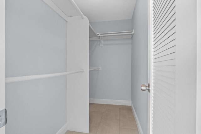 spacious closet featuring tile patterned floors
