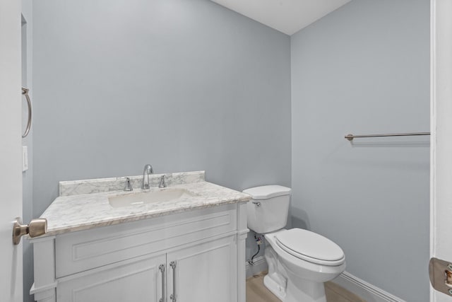 221 Normandy, Delray Beach, FL 33484 - half bathroom with toilet, vanity, and baseboards