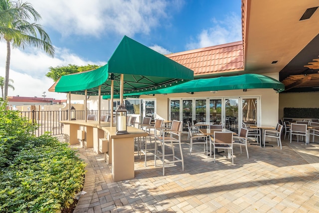 view of patio / terrace with fence and outdoor dry bar