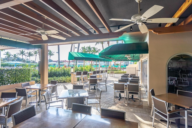 view of patio with ceiling fan and outdoor dining space