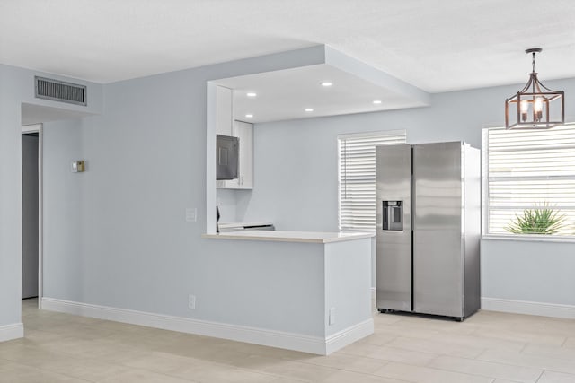 221 Normandy, Delray Beach, FL 33484 - kitchen featuring stainless steel fridge with ice dispenser, white cabinets, light countertops, plenty of natural light, and recessed lighting