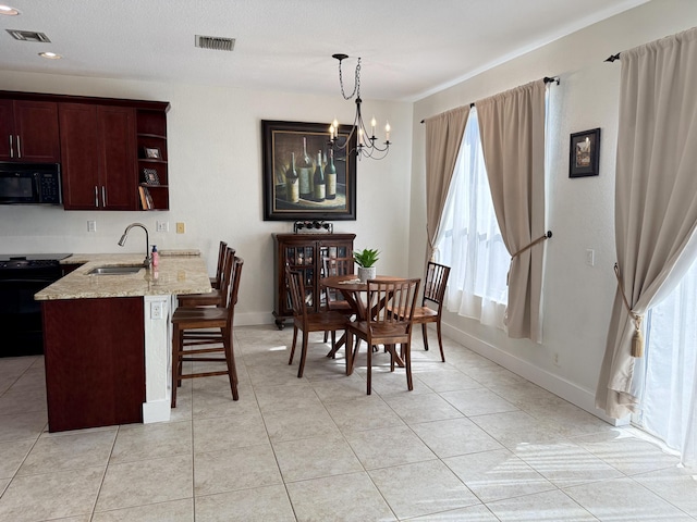 dining room with visible vents, a chandelier, and a wealth of natural light