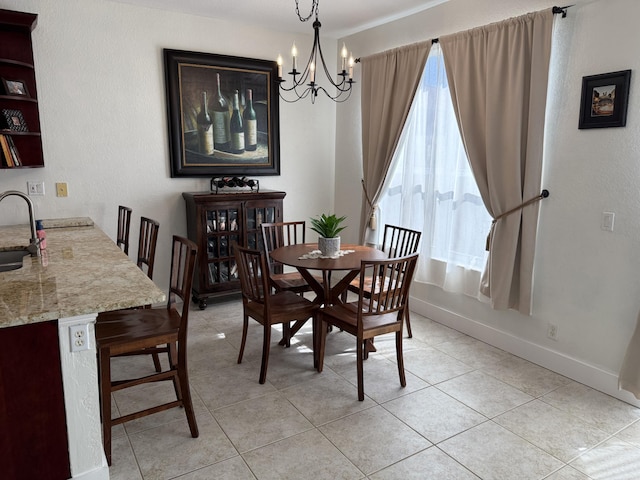 dining area with baseboards, an inviting chandelier, and light tile patterned floors