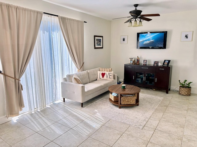 living room with light tile patterned floors and a ceiling fan